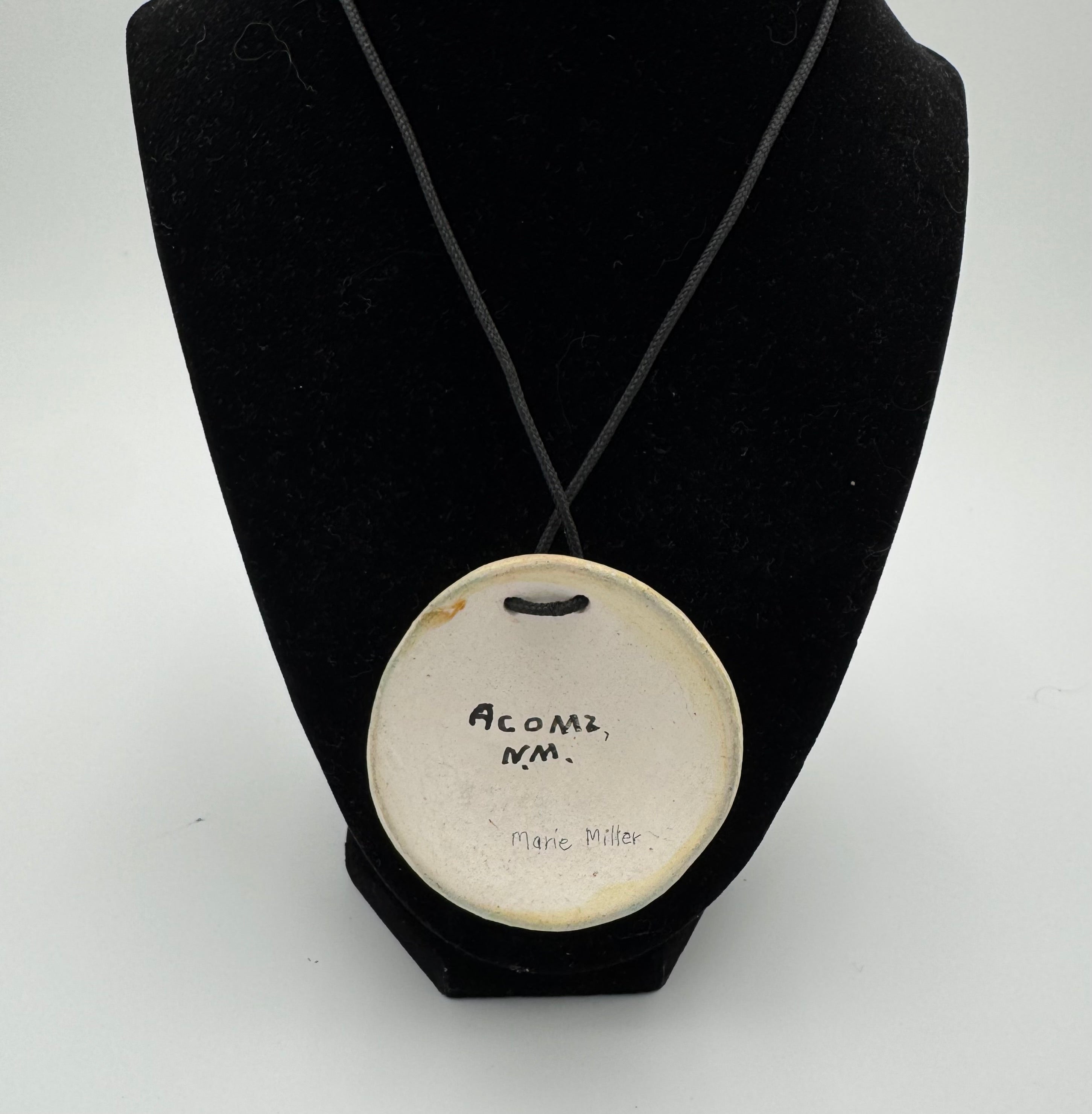 Hand-painted ceramic pendant by Marie Miller